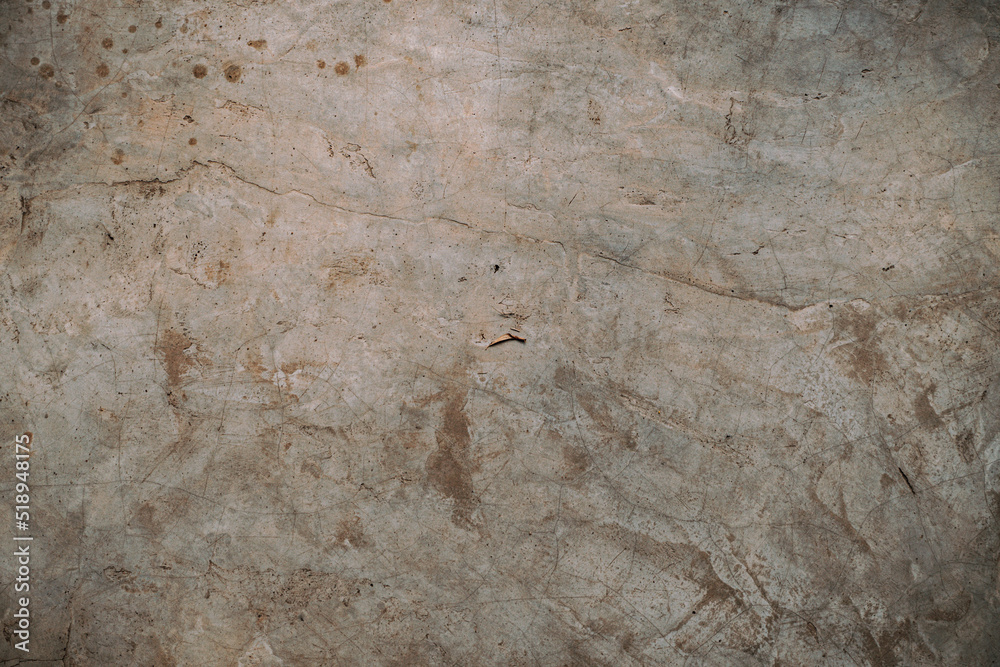 Destroyed cracked wall background, brown light texture, paint streaks.