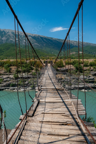 Permet, Albania A crumbling wooden and steel footbridge bridge over the Vjosa river © Alexander