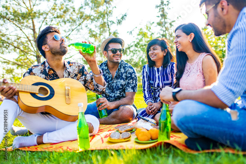 indian students having a lunch in Delhi park outdoors © yurakrasil