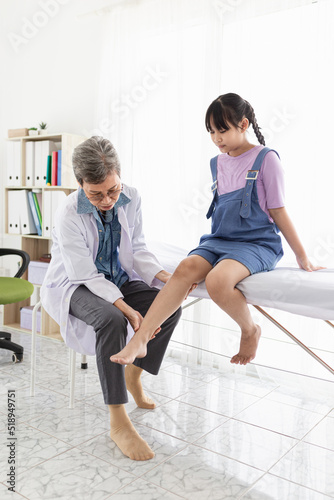 light and blur people, doctor holding leg of children patient in hospital, they training to rehab muscle