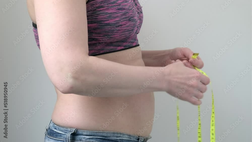 Woman hands holding fat belly on gray background, side view. Female ...