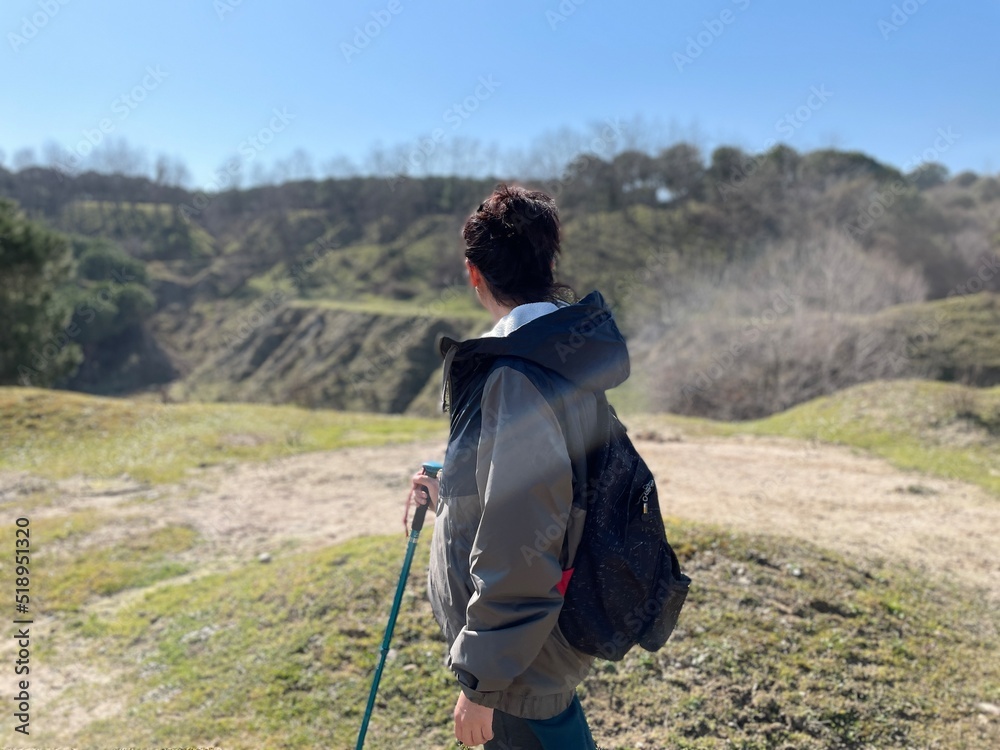 person with backpack hiking in the mountains