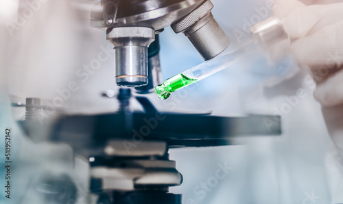 scientist with equipment and science experiments laboratory glassware containing chemical liquid. Health care researchers working in life science laboratory analyzing microscope slides in research lab