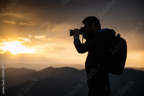 male photographer in nature at sunset