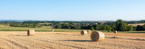 french countryside with straw bales under blue sky in north vosges park regional du vosges du nord