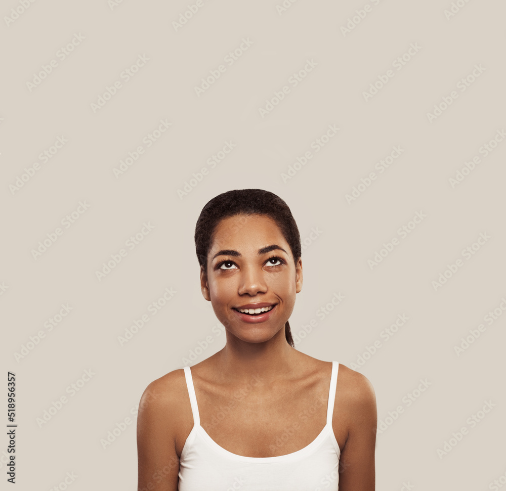 Happy young woman looking up on white background Happy young woman looking up on white background
