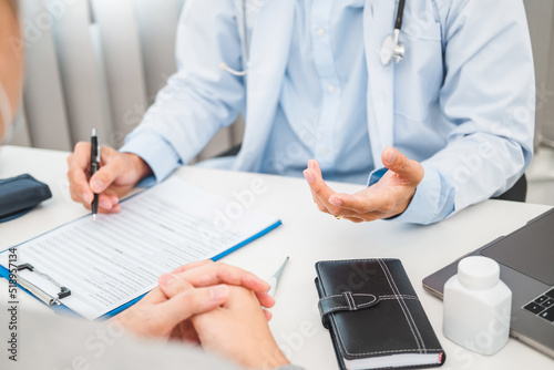 Doctors and patients sit and talk to the patient about medication in the hospital.