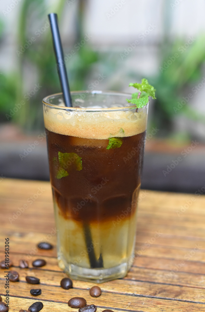 Ice lime espresso with mint and coffee beans on wooden table Ice lime espresso with mint and coffee beans on wooden table