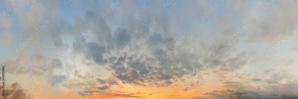 Colorful dramatic cloudscape background. Sunrise sky with clouds and sunlight