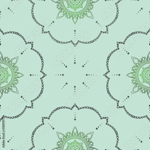 Seamless vector pattern with hand drawn mandala design with floral and dots. isolated on a soft green background. Perfect for printing on fabric or paper.