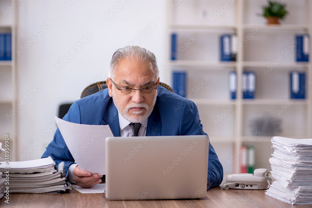 Old male employee and too much work in the office Old male employee and too much work in the office