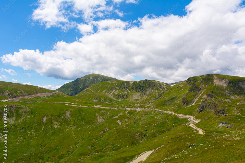Fototapeta premium Landscape from Transalpina serpentines on a summer day with a beautiful sky. Alpine routes in Romania and the highest mountain asphalt road in Romania and the Carpathians mountains