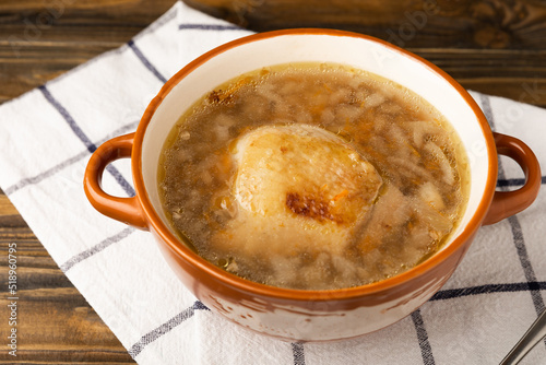 Buckwheat soup with carrots, potatoes and chicken on a brown wooden rustic table. Healthy food. Soup with croutons, garlic and spices. Copy space.