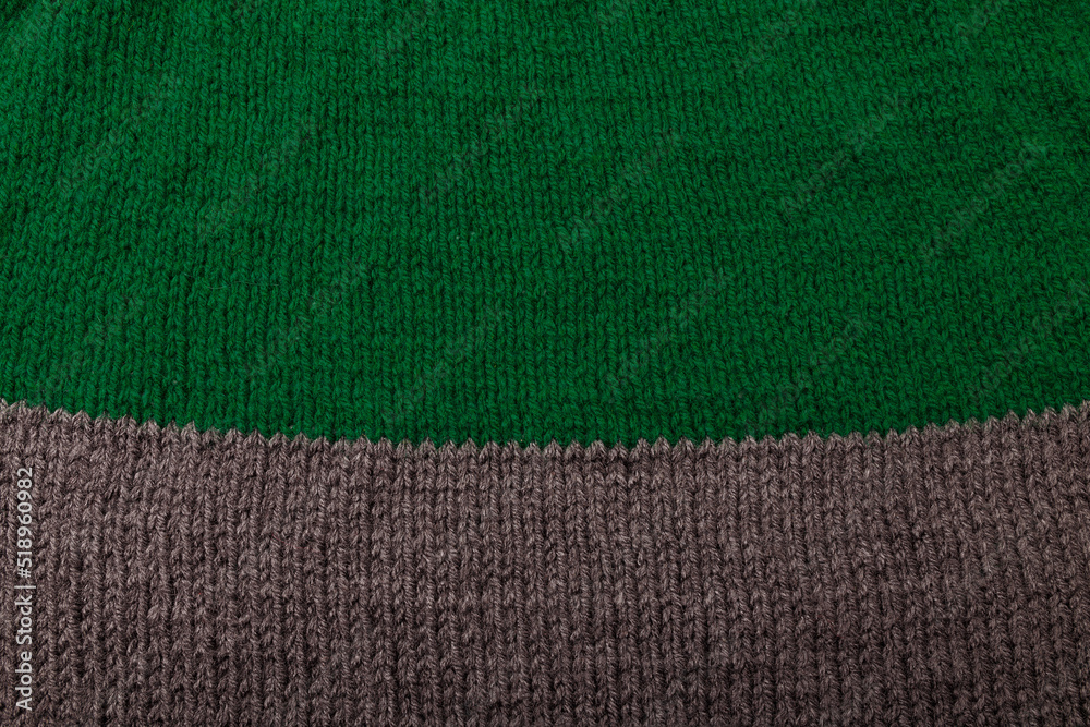 Fototapeta premium Knit striped green grey fabric texture, background. Textile, sweatshirt or sweater textured surface. Warm accessories, clothing, fashion