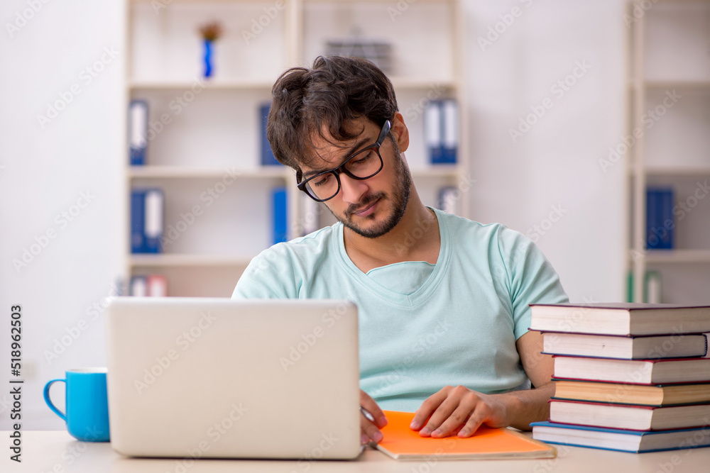 Young male student preparing for exams in the classroom Young male student preparing for exams in the classroom