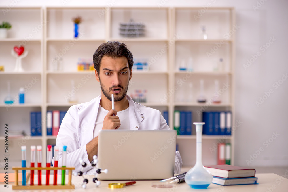 Young male chemist working at the lab Young male chemist working at the lab