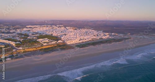 4K Aerial views - Conil de la Frontera - Beautiful aerial views of sunset on the beach taken with a drone of the wonderful coastal town of Conil de la Frontera in the province of Cádiz photo