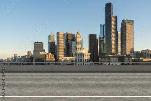 Empty urban asphalt road exterior with city buildings background. New modern highway concrete construction. Concept way to success. Transportation logistic industry fast delivery. Seattle. USA.