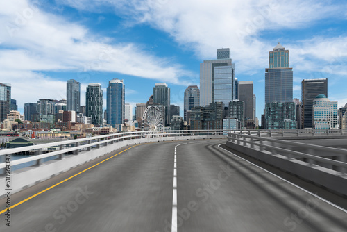 Empty urban asphalt road exterior with city buildings background. New modern highway concrete construction. Concept way to success. Transportation logistic industry fast delivery. Seattle. USA.