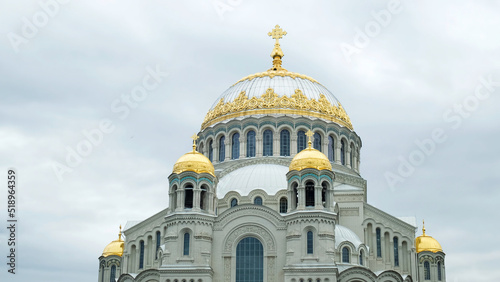 Naval cathedral in Kronstadt, Saint Petersburg, Russia. Concept. Amazing church with gold domes on cloudy sky background, religion and architecture theme. photo