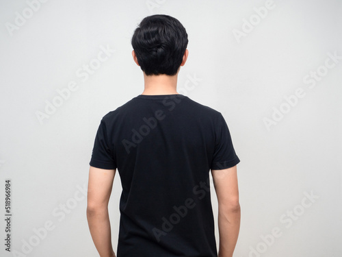 Portrait man black shirt standing turn back studio shot
