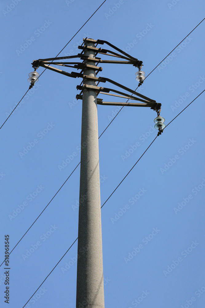 reinforced concrete pole with the supports and insulators of the high voltage power line for the transport of electricity reinforced concrete pole with the supports and insulators of the high voltage power line for the transport of electricity