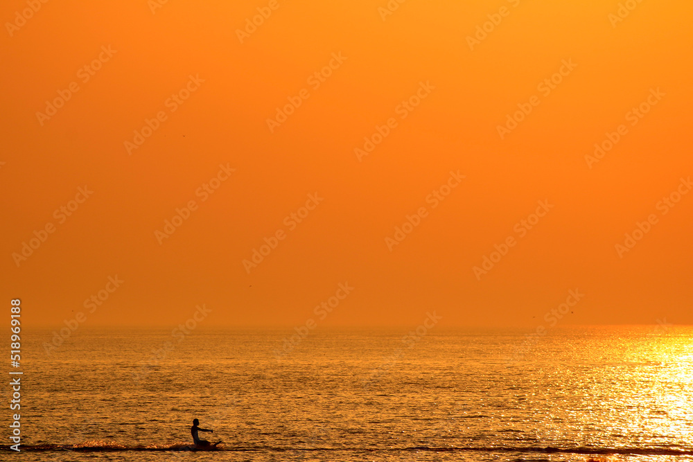 water skiing at sea in the setting sun