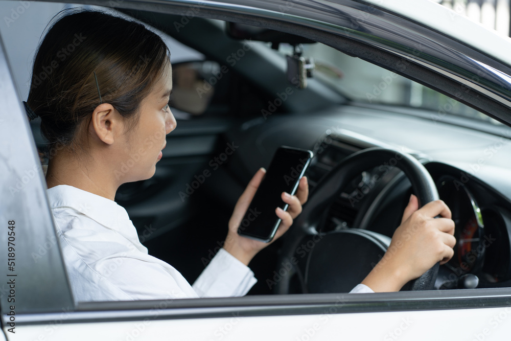 Asian using smartphone while driving