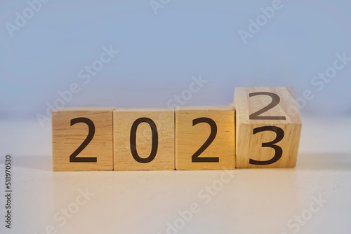 Goals moving forward to 2023, road to next, numbers on wooden box on blue background.,Entering 2023