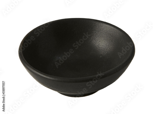 Black empty ceramic dip bowl close up. Isolated over white background