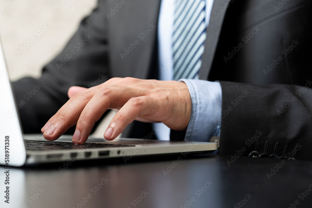 Close-up photo of male hand typing on keyboard in the office Close-up photo of male hand typing on keyboard in the office