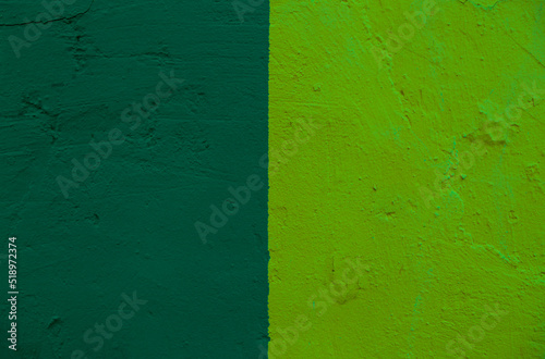 Abstract background from two green color shades on the wall.