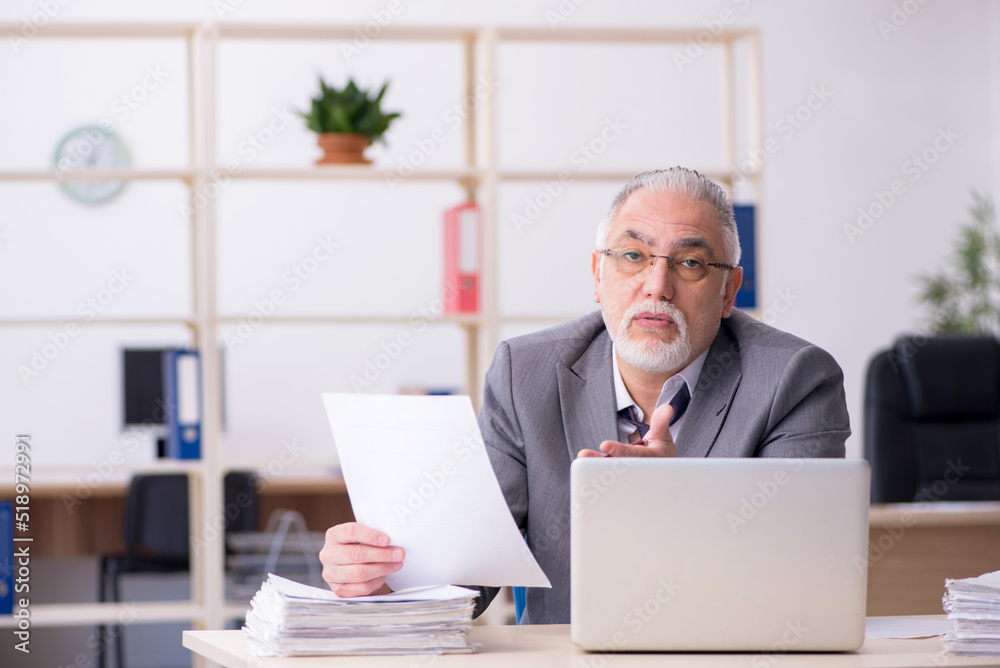 Old male employee and too much work in the office Old male employee and too much work in the office