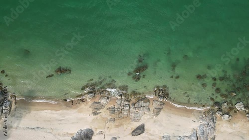 Aerial view of Seascape beach and ocean , Drone footage 4k flying , clear sea water and rock sand beach