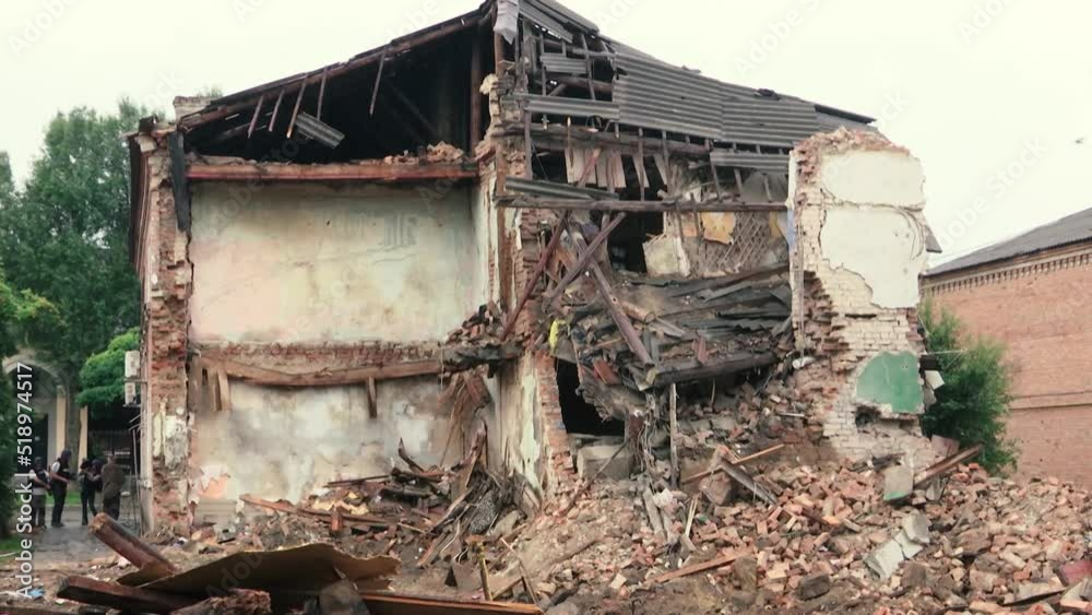 A residential building destroyed by a missile attack from the Russian army. Nearby lies a lot of bricks, there are burnt trees A residential building destroyed by a missile attack from the Russian army. Nearby lies a lot of bricks, there are burnt trees