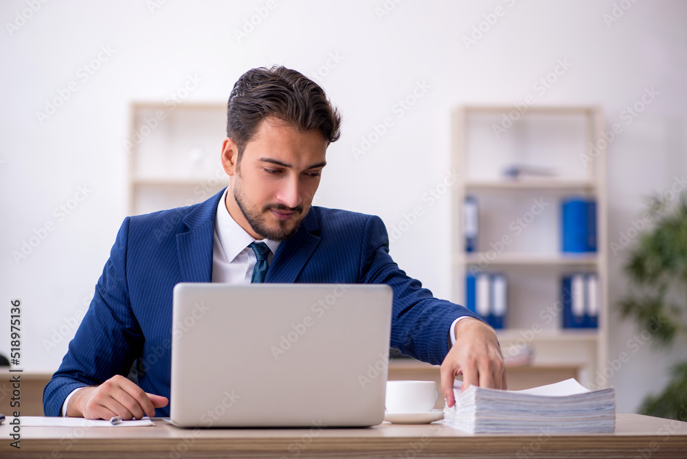 Young male employee working in the office Young male employee working in the office