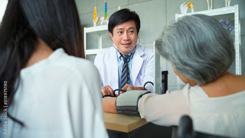 Male doctor measuring the patient's blood pressure Senior woman in the hospital. Male doctor measuring the patient's blood pressure Senior woman in the hospital.