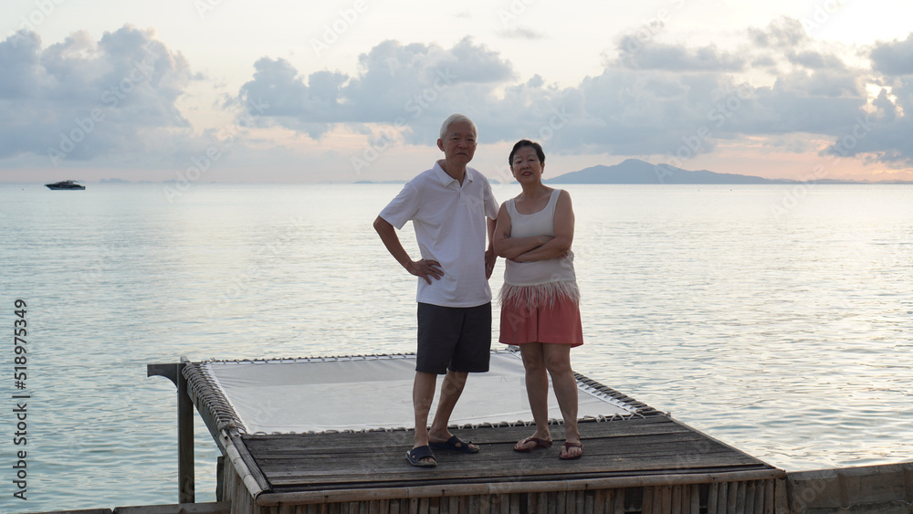 Asian senior elder couple relax enjoy have fun on tropical seaside morning vacation retirement trip Asian senior elder couple relax enjoy have fun on tropical seaside morning vacation retirement trip