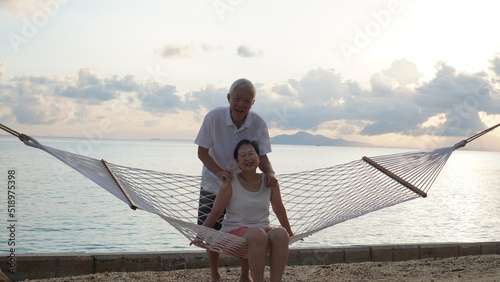 Asian senior elder couple relax enjoy have fun on tropical seaside morning vacation retirement trip