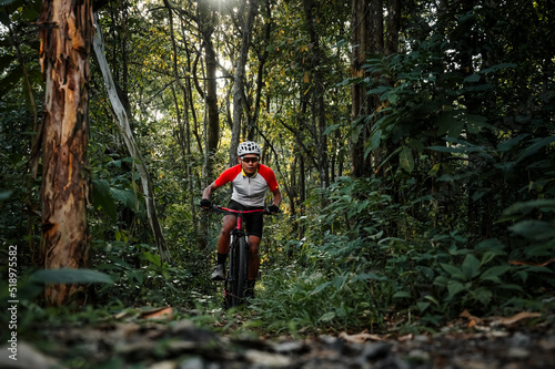 Mountain bikers ride MTB, mountain bike downhill to the extreme. Asian man rides MTB, mountain bike downhill in the wild to extremes. Extreme Sport and MTB, mountain bike downhill Concept.