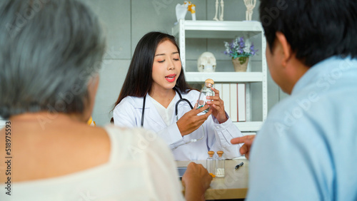 Specialist female doctor is introducing a way to use medicines to patients. to restore the health of the old woman. The female patient's son listened attentively to the advice of the female doctor.