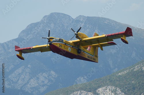 Canadair in fase di ricarica presso il lago di Cavazzo, Udine, Italia photo