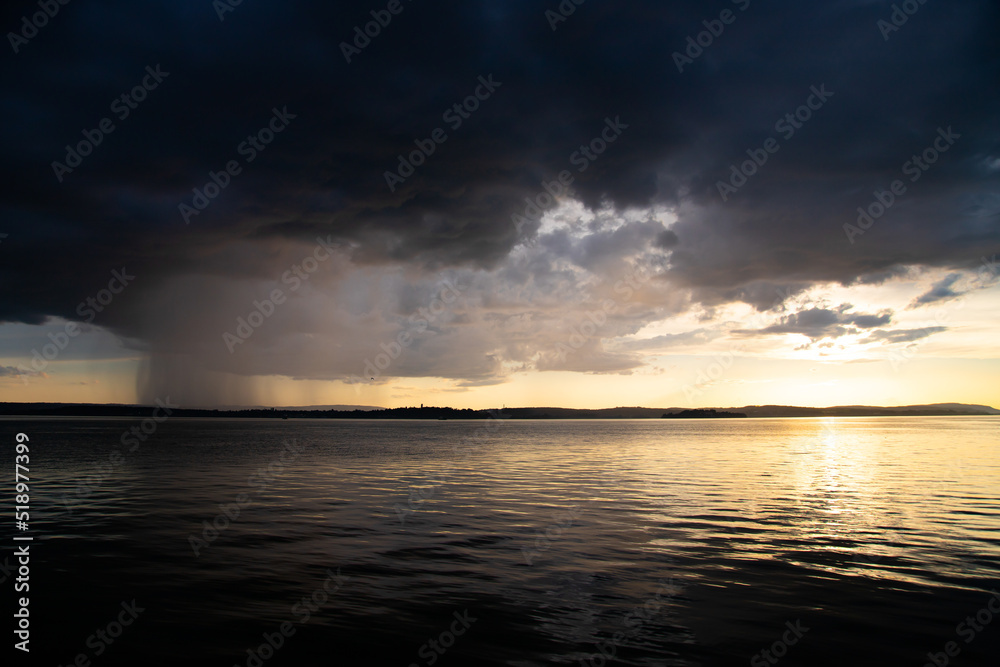 Heavy dark fast moving thunderstorm clouds over lake Constance, Germany Heavy dark fast moving thunderstorm clouds over lake Constance, Germany