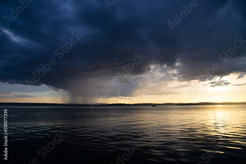 Heavy dark fast moving thunderstorm clouds over lake Constance  Germany