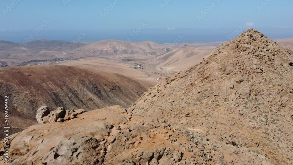aerial view from behind the top of the mountain on the desert landscape of fuerteventura island aerial view from behind the top of the mountain on the desert landscape of fuerteventura island