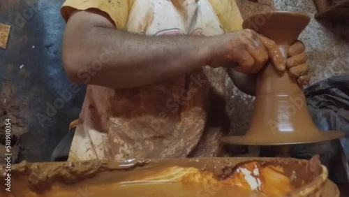 Potter makes the clay product with pottery on the potter's wheel. pottery, workshop, ceramics art concept.
