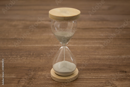Image of a sand hourglass. Reference to the passing of time