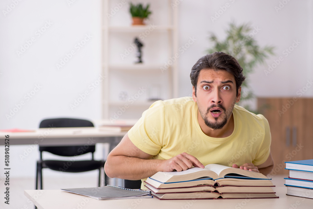 Young male student preparing for exams in the classroom Young male student preparing for exams in the classroom