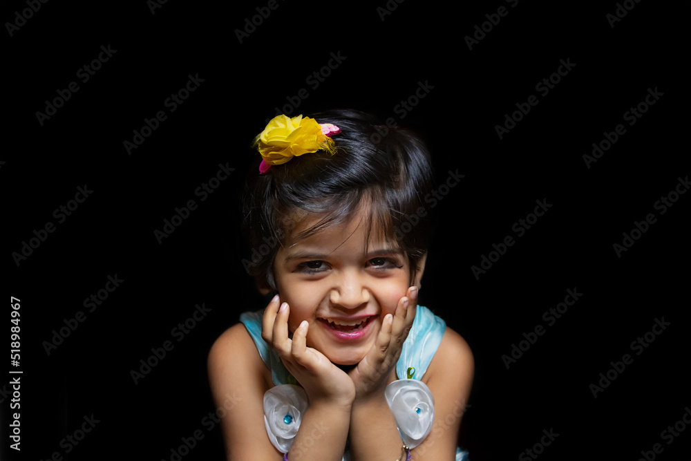 Portrait of a happy Indian girl holding chin in hand Portrait of a happy Indian girl holding chin in hand