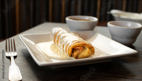 Chimichanga covered in cheese sauce